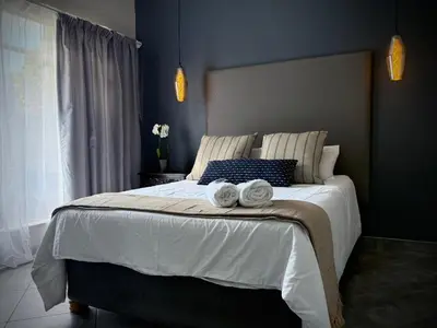 a bedroom with a large bed with towels on it at Olive Branch in Bethal