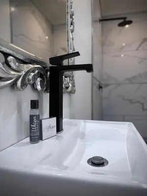 a bathroom sink with a black faucet on it at Olive Branch in Bethal