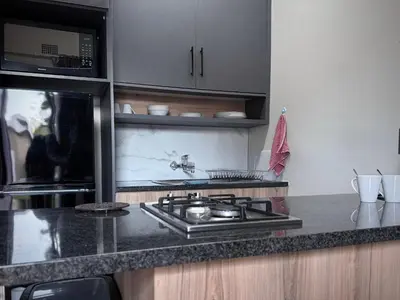 a kitchen with a stove and a microwave at Olive Branch in Bethal
