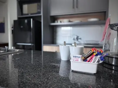 a kitchen counter with three white cups on a counter top at Olive Branch in Bethal