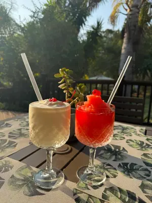 two cocktails sitting on top of a table at Ezulwini - Kruger Park Lodge Golf Estate in Hazyview