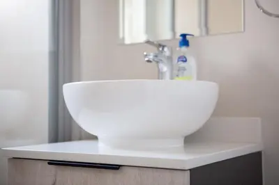 a white sink sitting on top of a bathroom counter at Oasis Comfort Apartment in Midrand