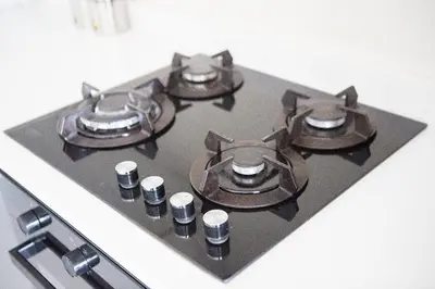 a stove top with four burners on top of it at Oasis Comfort Apartment in Midrand