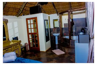 a bathroom with a sink and a toilet in a room at Fairy Gardens Lodge in Pretoria