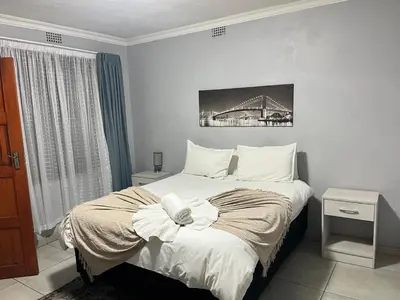 a bedroom with a bed and a bridge in it at Mogoma Guesthouse in Witbank