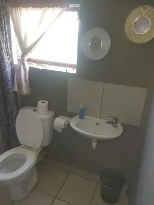 a bathroom with a toilet and a sink at Chalet 5 At Cynthias Country in Hartbeespoort