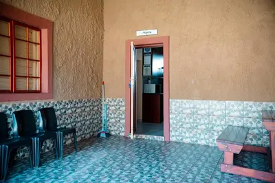 a room with a door with chairs and a table at Falcon Lodge Bela in Bela-Bela