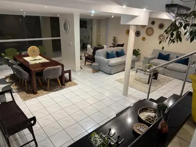 a kitchen and living room with a couch and a table at Olives by Agnes 33 in Hartbeespoort