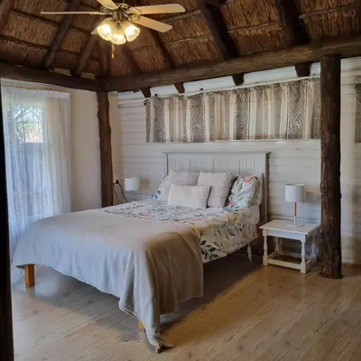 a bedroom with a bed and a ceiling fan at Kruin cottage in Pretoria
