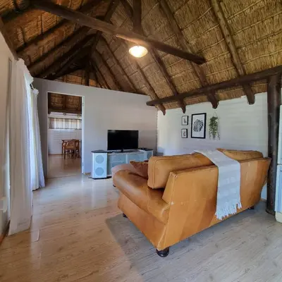 a living room with a couch and a television at Kruin cottage in Pretoria