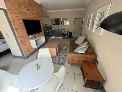 a living room with a couch and a table at Junction 30 in Pretoria