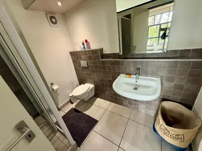 a bathroom with a sink and a toilet and a mirror at Junction 30 in Pretoria