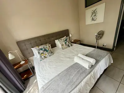 a bedroom with a bed with towels on it at Junction 30 in Pretoria