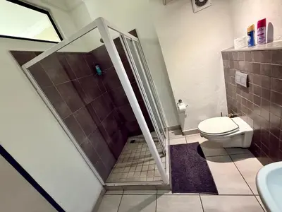 a bathroom with a shower and a toilet at Junction 30 in Pretoria