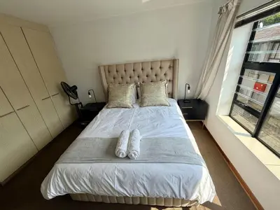 a bedroom with a bed with two towels on it at Lynwood 919 in Pretoria