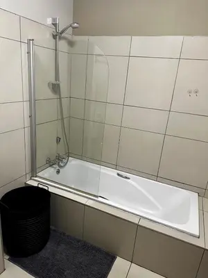a bathroom with a bath tub with a shower at Lynwood 919 in Pretoria