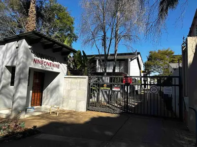 a building with a gate in front of a house at Lynwood 919 in Pretoria