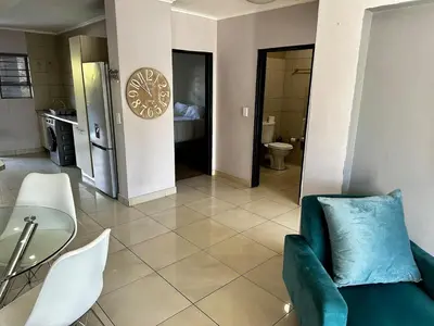 a living room with a couch and a table at Lynwood 919 in Pretoria