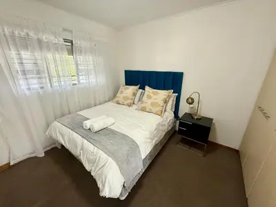 a bedroom with a large bed with a window at Lynwood 919 in Pretoria