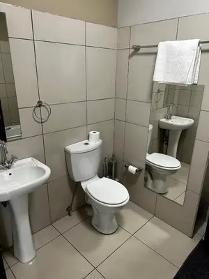 a bathroom with a toilet and a sink at Lynwood 919 in Pretoria