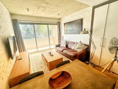 a living room with a couch and a table at Menlo Gate in Pretoria
