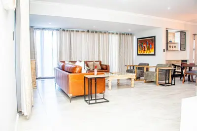 a living room with a couch and a table at Batau Villa in Naboomspruit