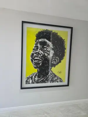 a framed painting of a black woman on a wall at Batau Villa in Naboomspruit