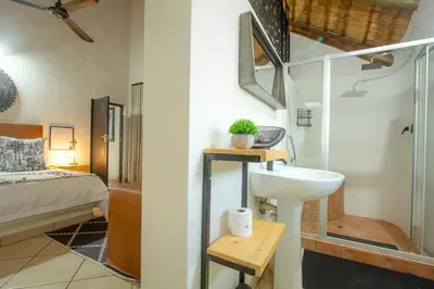 a bathroom with a sink and a shower at Stay at Royal in Marloth Park