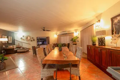 a living room with a wooden table and chairs at Stay at Royal in Marloth Park