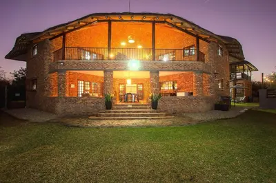 a large brick building with stairs in front of it at Stay at Royal in Marloth Park