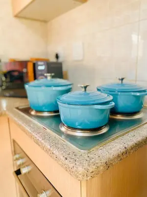 three blue bowls sitting on a counter in a kitchen at Phoenix Rising Apartment in Midrand