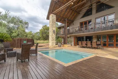 a house with a swimming pool on a wooden deck at Beautiful 4-bedroom, 33 Zebula in Warmbaths