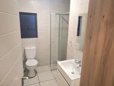 a bathroom with a toilet and a sink at KD Homes in Pretoria
