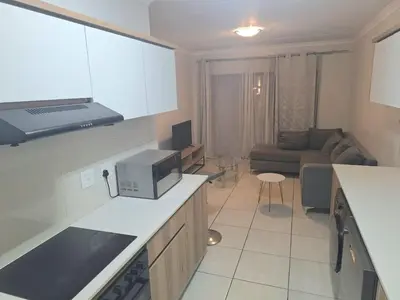 a kitchen and living room with a couch at KD Homes in Pretoria