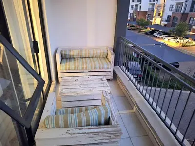 a balcony with two chairs on a balcony at KD Homes in Pretoria