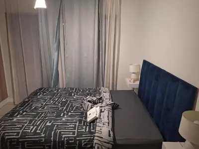 a bedroom with a bed with a black and white comforter at KD Homes in Pretoria