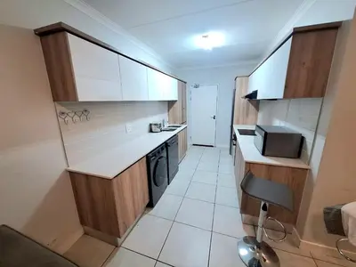 a small kitchen with a counter and a sink at KD Homes in Pretoria