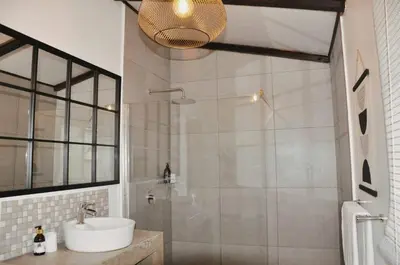 a bathroom with a shower with a sink and a sink at Stayfit 01 in Polokwane
