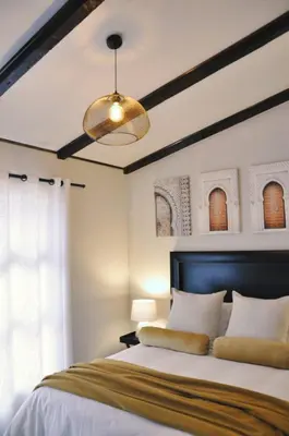 a bedroom with a large bed and a ceiling at Stayfit 01 in Polokwane
