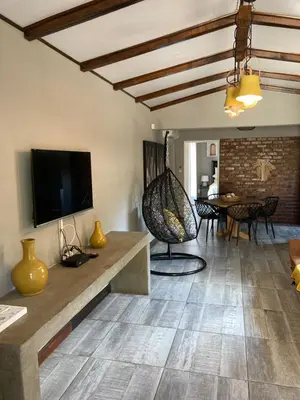 a living room with a flat screen tv and a table at Stayfit 01 in Polokwane