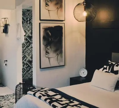 a bedroom with black and white pictures on the wall at StayFit 02 in Polokwane