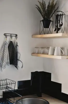 a kitchen with black and white shelves and a sink at StayFit 02 in Polokwane