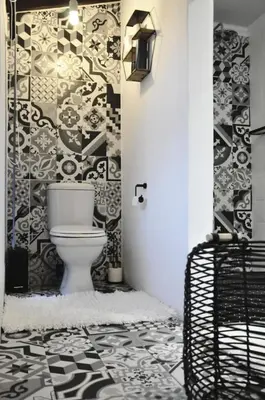 a bathroom with a toilet and a black and white wallpaper at StayFit 02 in Polokwane