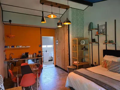 a bedroom with a bed and a table and chairs at Stayfit 03 in Polokwane