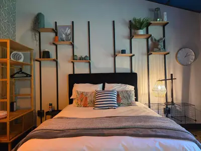a bedroom with a bed with pillows and shelves at Stayfit 03 in Polokwane