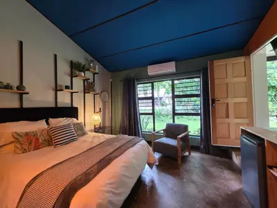 a bedroom with a large bed with a blue ceiling at Stayfit 03 in Polokwane