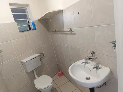 a bathroom with a white toilet and a sink at TRIANGLE STARS Guest House in Kempton Park