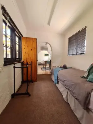 a bedroom with two beds and a mirror in it at Midrand-Living Water's Sanctuary in Midrand