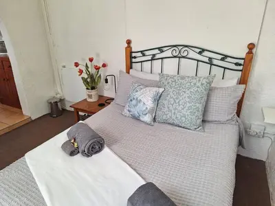 a bedroom with a large bed with pillows at Midrand-Living Water's Sanctuary in Midrand