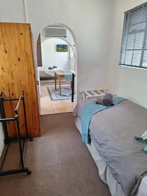 a room with two beds and a bathroom with a mirror at Midrand-Living Water's Sanctuary in Midrand